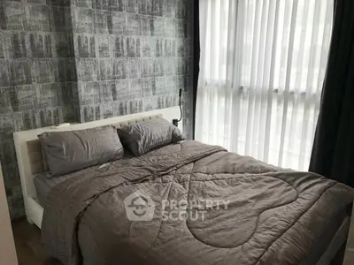 Cozy bedroom with modern decor and large window for natural light