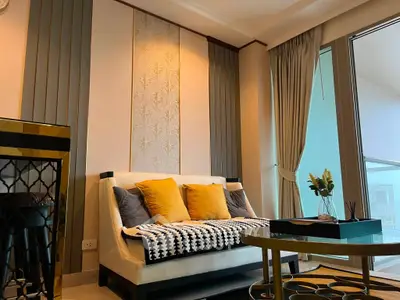 Stylish living room with elegant decor and large windows offering natural light.