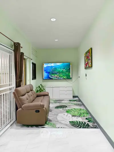 Modern living room with sleek decor and wall-mounted TV