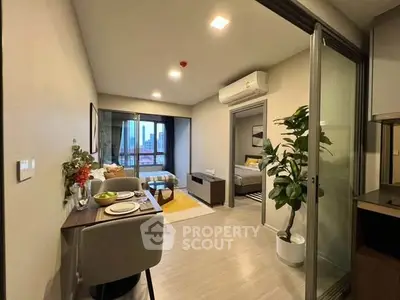 Modern apartment interior with open layout, featuring a cozy living area and stylish dining space.