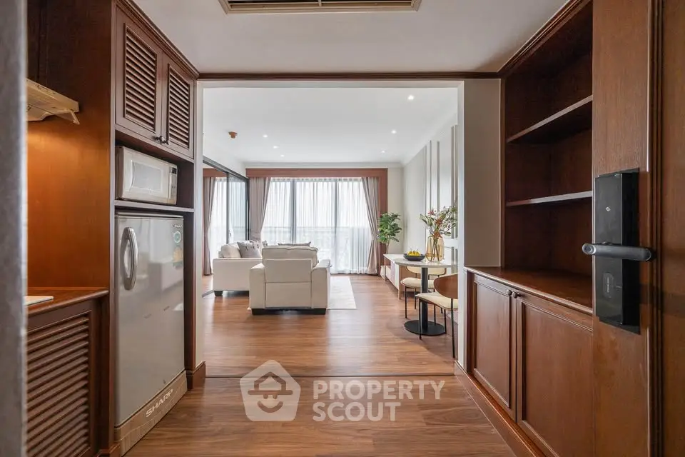 Spacious open-plan living room with elegant wooden flooring and modern furnishings