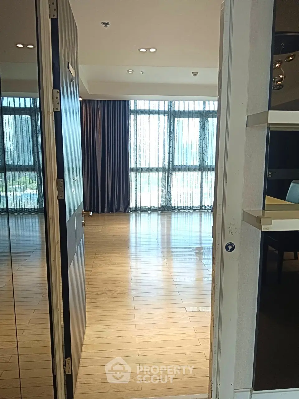Spacious modern apartment with wooden flooring and large windows