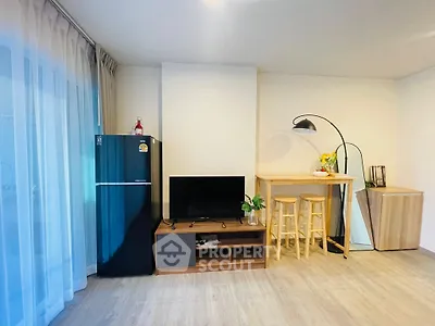 Modern living room with stylish decor, featuring a TV, fridge, and breakfast bar with stools.