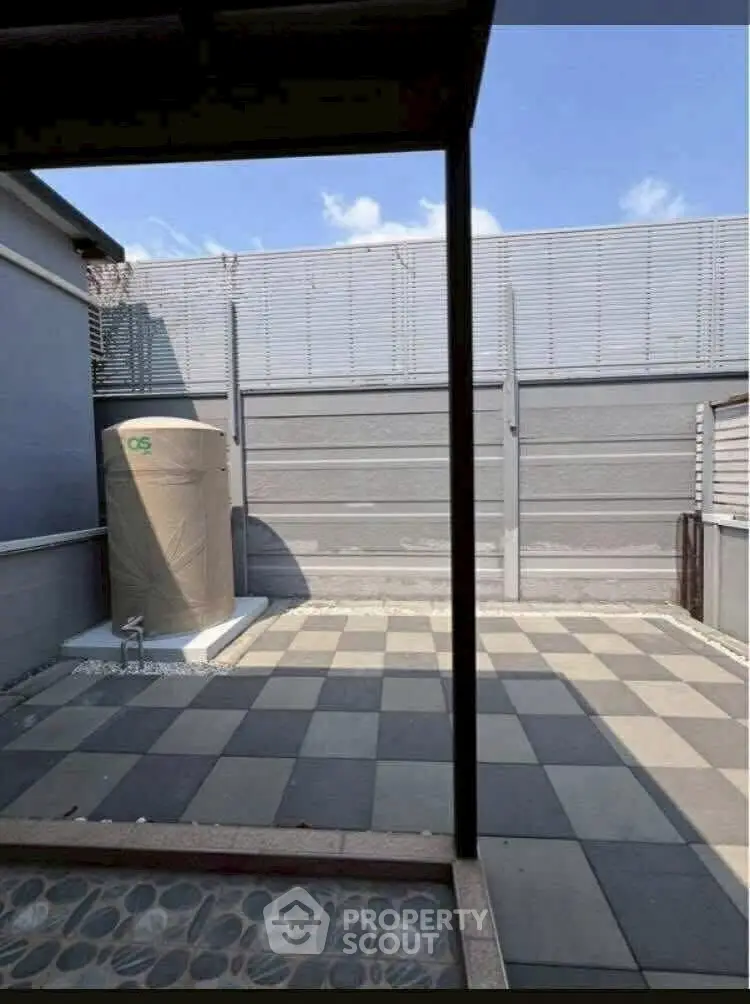 Spacious outdoor patio with modern design and ample sunlight, perfect for relaxation.