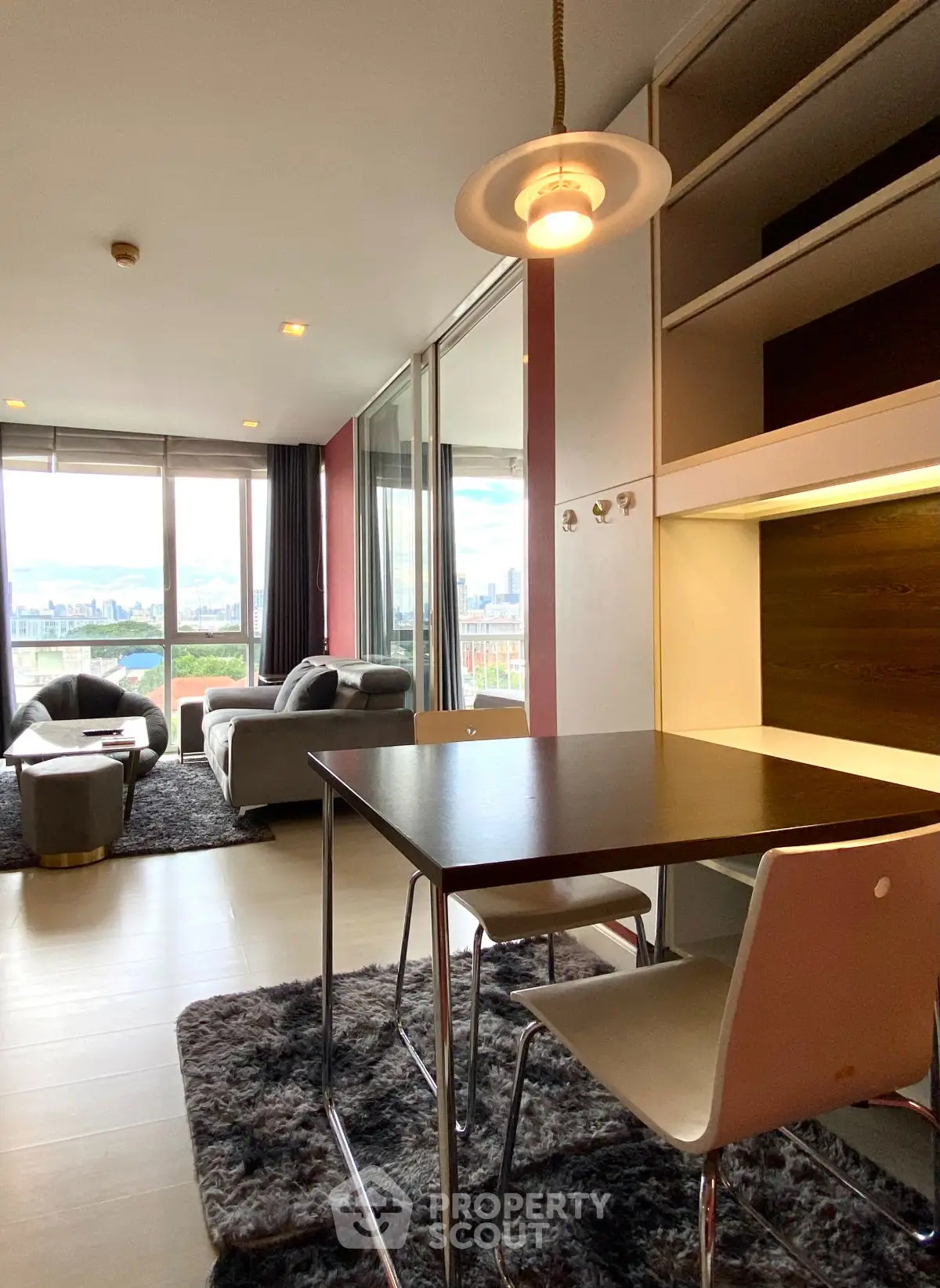 Modern living room with city view, stylish furniture, and open layout for urban living.