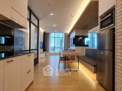 Modern open-plan kitchen and living area with sleek design and city view.