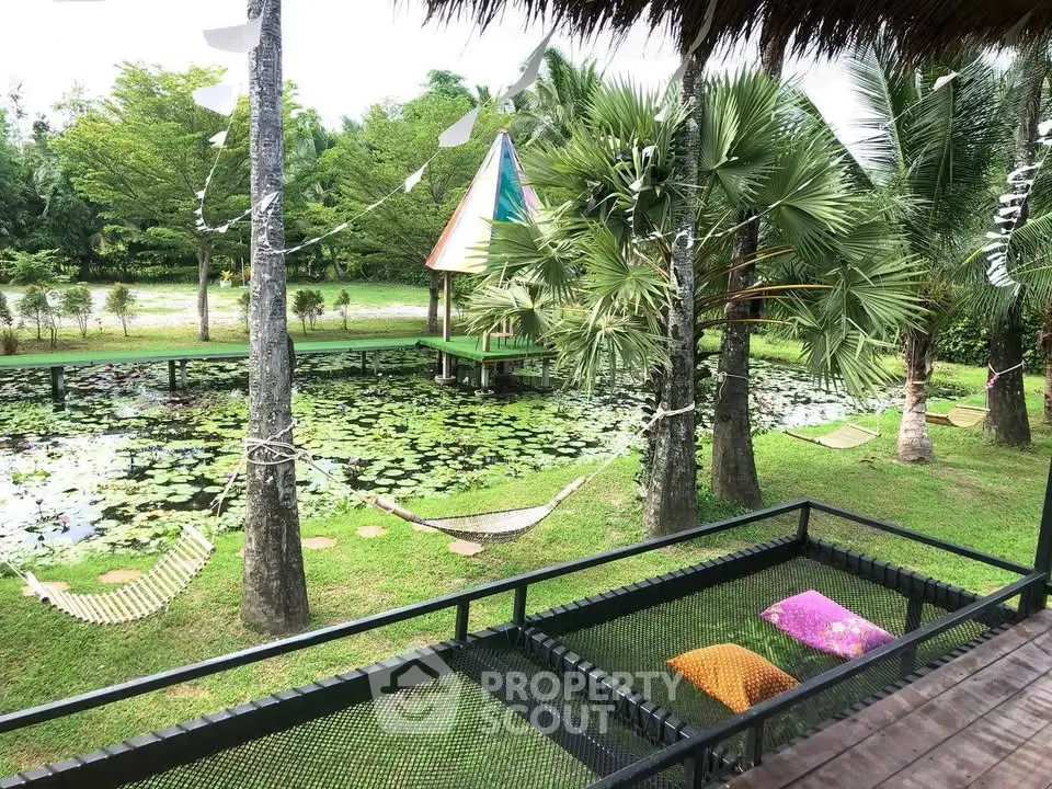 Serene garden view with lush greenery and tranquil pond, perfect for relaxation and outdoor enjoyment.