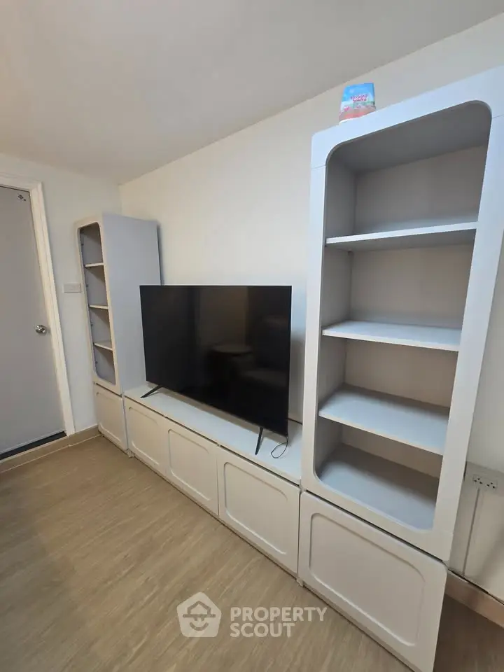 Modern living room with sleek TV unit and stylish shelving