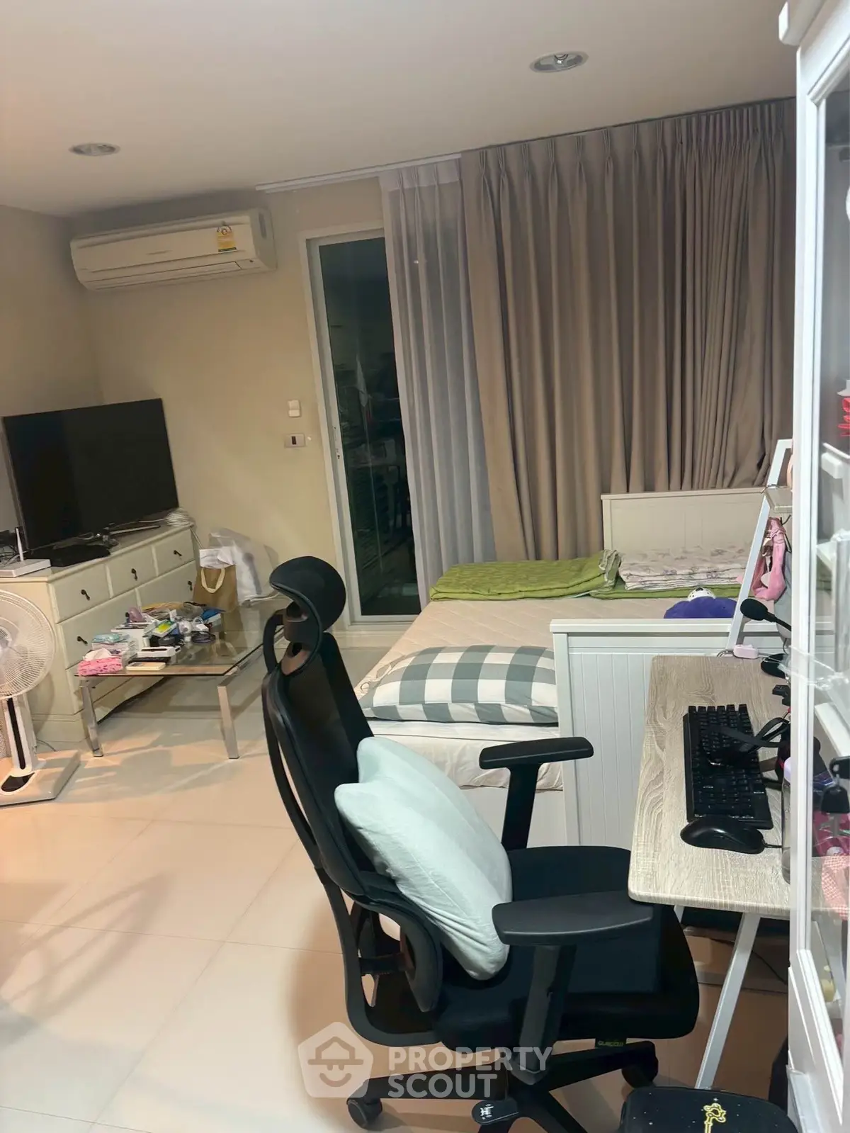 Modern bedroom with workspace, featuring a sleek desk and comfortable chair, ideal for productivity and relaxation.