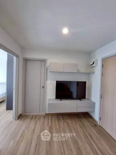 Modern living room with sleek TV unit and wooden flooring, perfect for contemporary living.