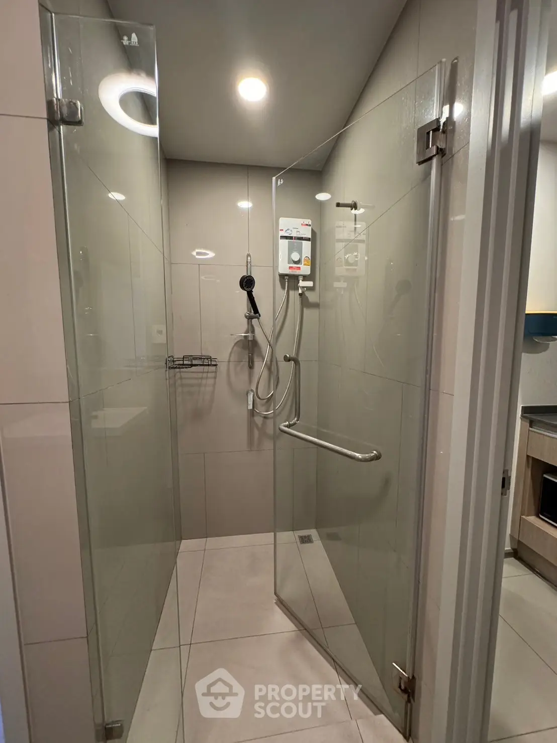 Modern bathroom with glass shower enclosure and sleek fixtures