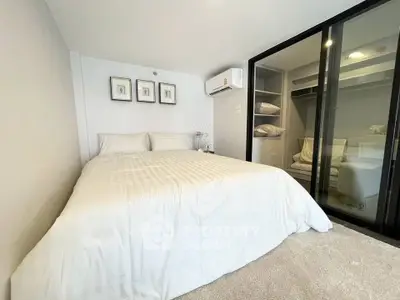 Modern bedroom with cozy bed and built-in closet in a stylish apartment.