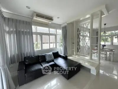 Spacious living room with modern decor and large windows in a stylish home