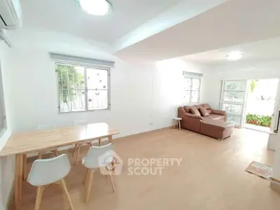 Bright and spacious living room with modern furniture and large windows.