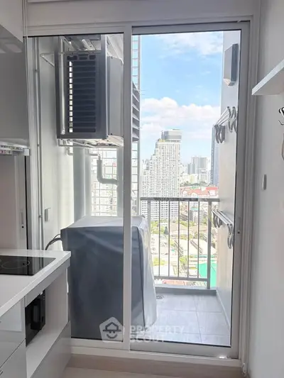 Modern high-rise apartment balcony with city view and laundry area.