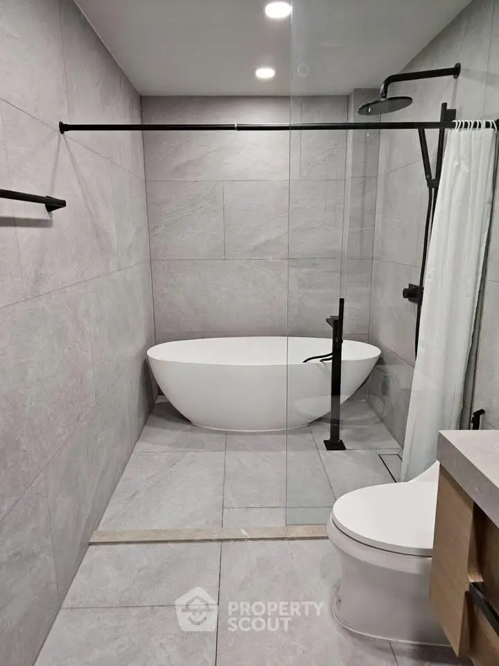 Modern bathroom with sleek freestanding bathtub and elegant fixtures
