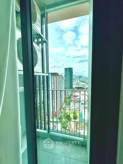 Stunning city view from a modern apartment balcony with air conditioning units.