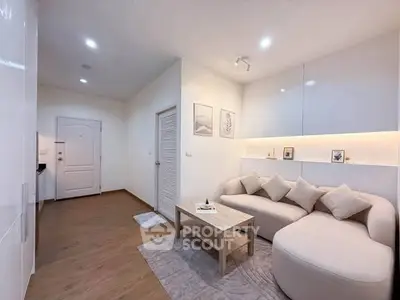 Modern living room with cozy sofa and stylish decor in a bright apartment.