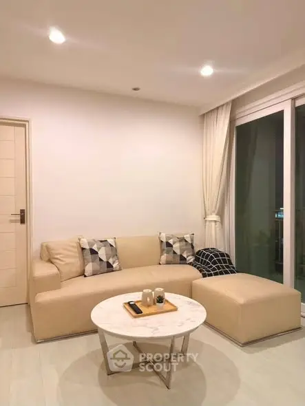 Modern living room with beige sofa and stylish decor in a cozy apartment.