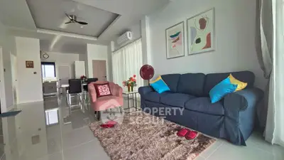 Stylish modern living room with plush seating and elegant decor in a spacious open layout.