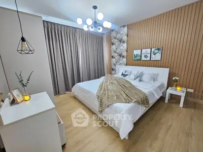 Modern bedroom with stylish decor and cozy ambiance, featuring elegant lighting and wooden accents.