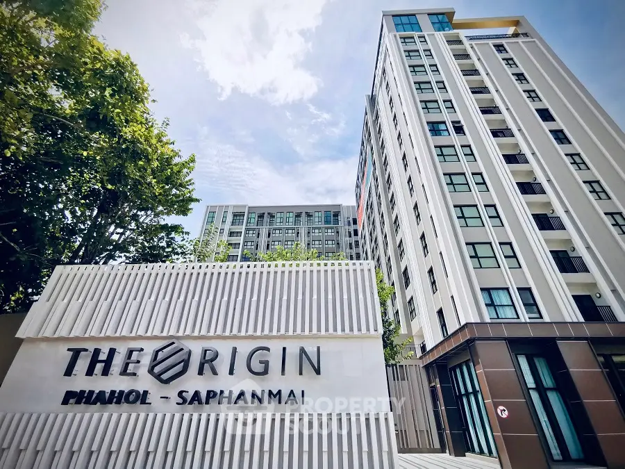 Modern high-rise building with sleek design at The Origin Phahol Saphanmai.