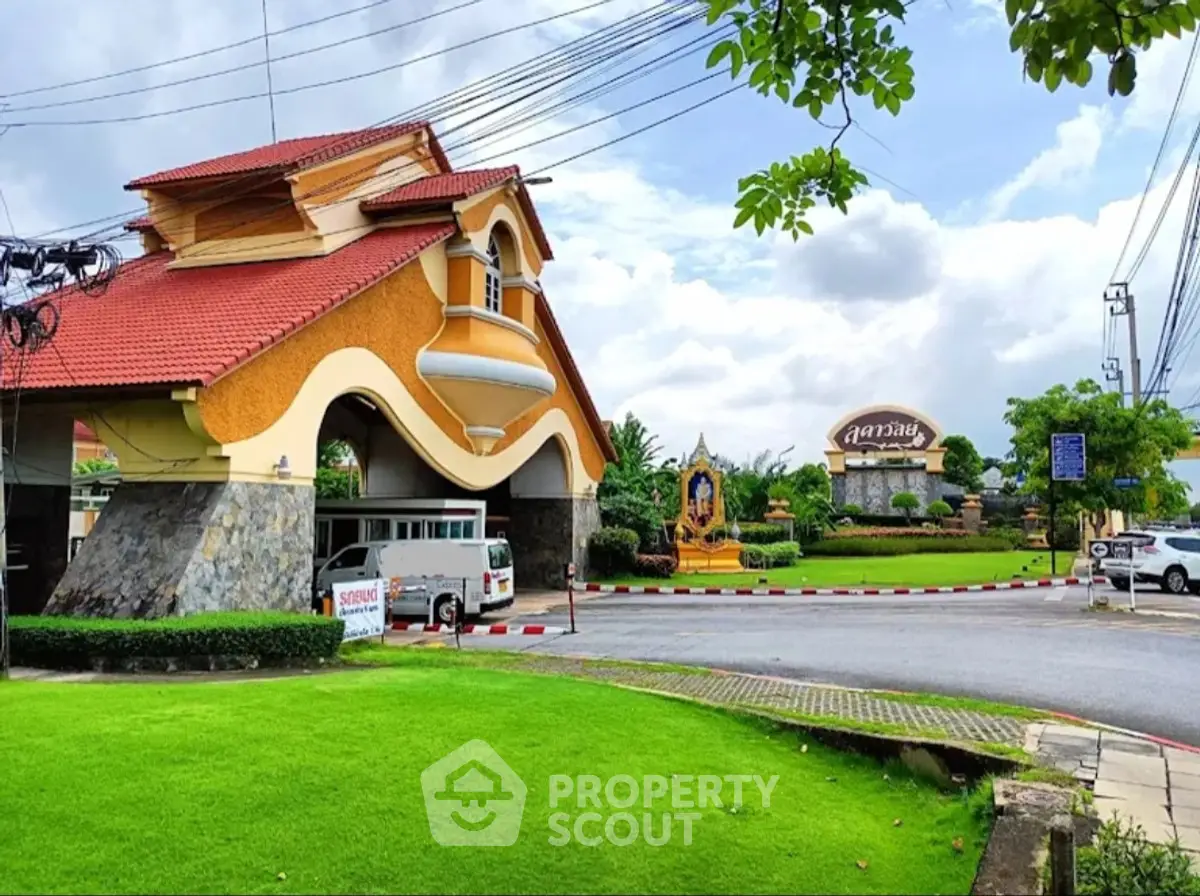Charming residential entrance with lush landscaping and unique architectural design.