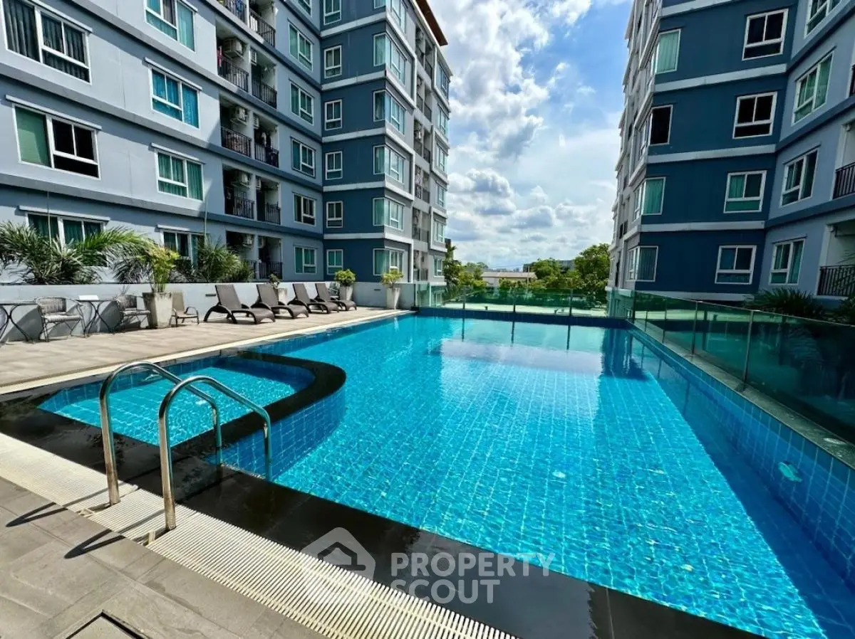 Luxurious apartment complex with a stunning outdoor pool and modern architecture.