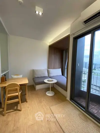 Modern apartment interior with cozy seating and city view balcony