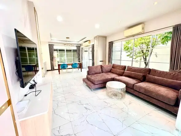 Spacious modern living room with large windows and stylish furniture