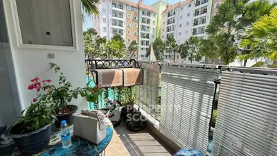 Charming balcony with pool view in modern apartment complex
