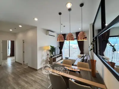 Modern living room with stylish decor and large windows offering a stunning city view.