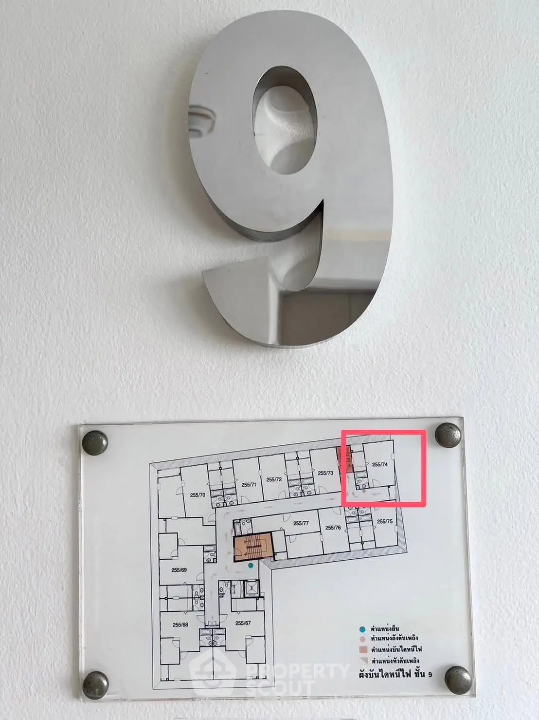Floor plan with unit layout on a white wall, marked with number 9.