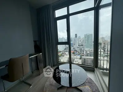 Modern living room with stunning city view from large windows, featuring sleek furniture and elegant decor.