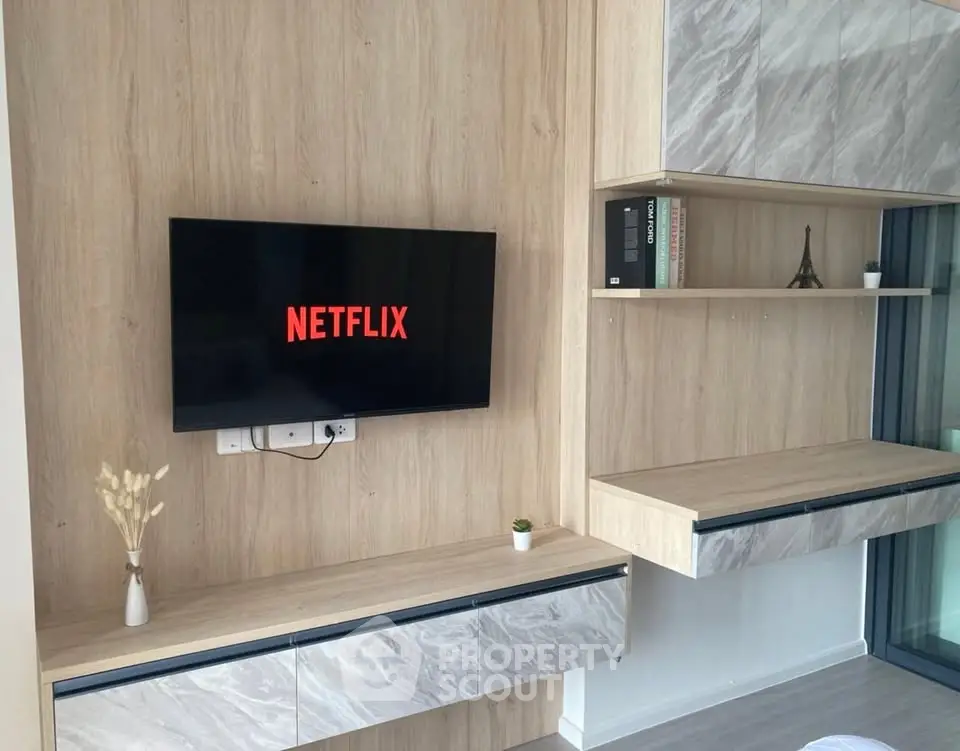 Modern living room with stylish wooden paneling and wall-mounted TV