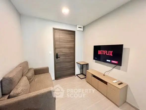 Cozy living room with modern TV setup and comfortable sofa