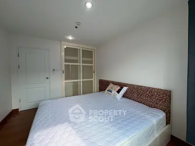 Spacious bedroom with elegant design and ample natural light, featuring a large bed and stylish wardrobe.