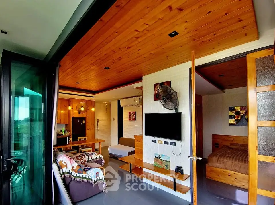 Modern open-plan living room with wooden ceiling and stylish decor