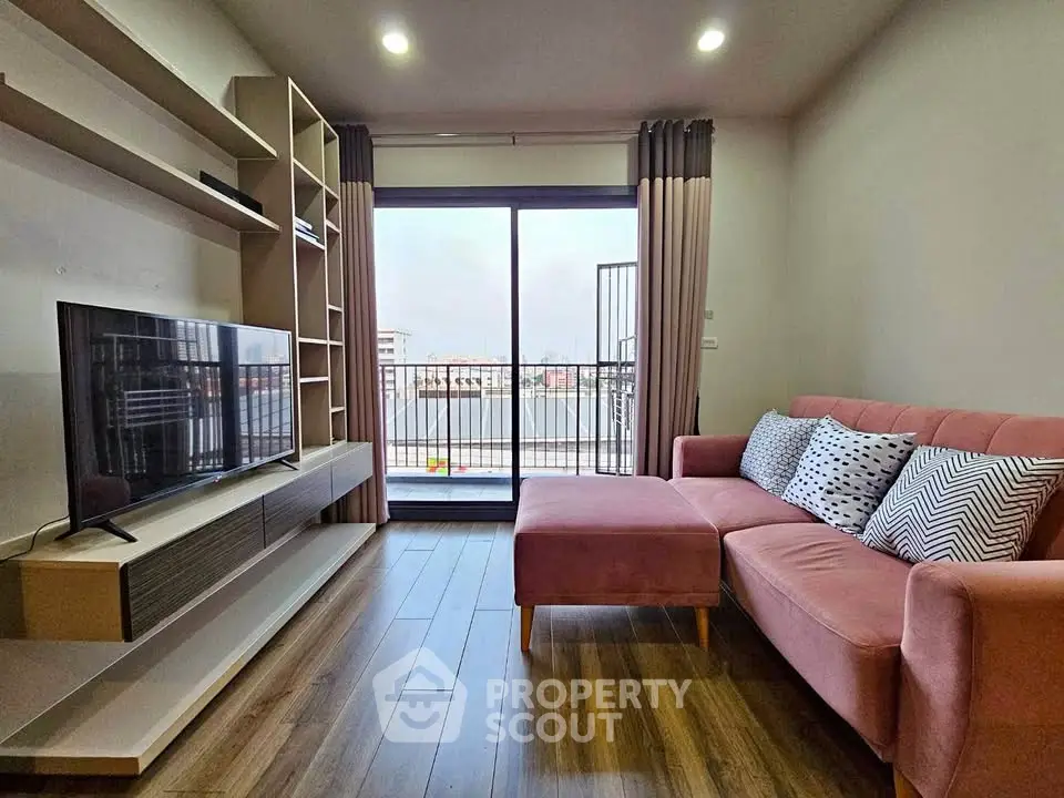 Modern living room with pink sofa and balcony view