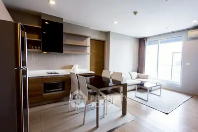 Modern open-plan kitchen and living room with sleek furniture and natural light.