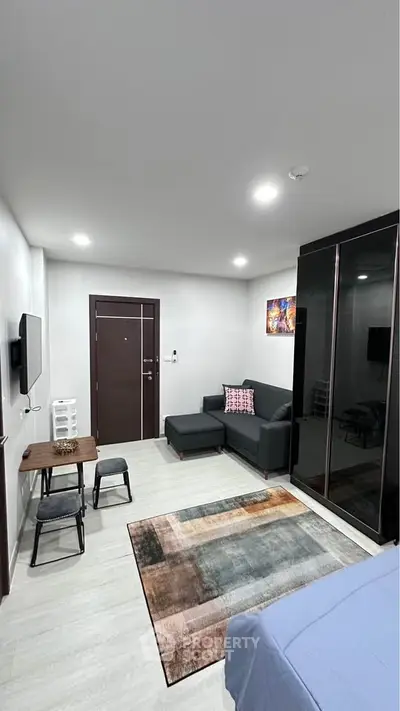 Modern studio apartment with cozy living area and stylish decor
