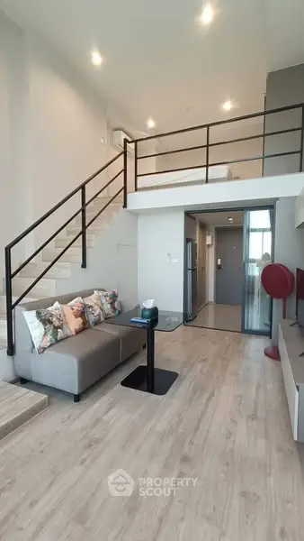 Modern loft-style living room with high ceiling and stylish decor