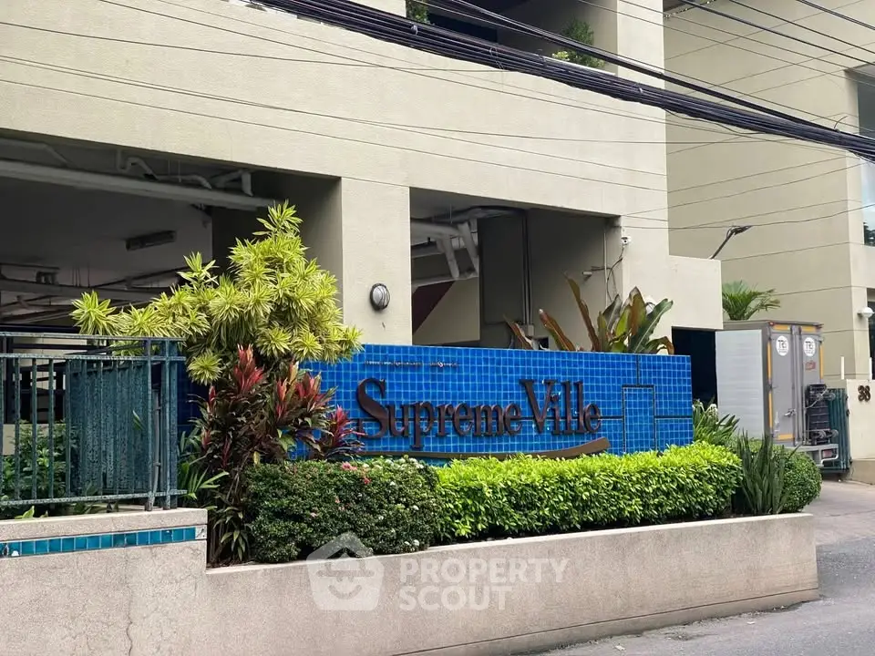 Elegant entrance of Supreme Villa with lush greenery and modern design.