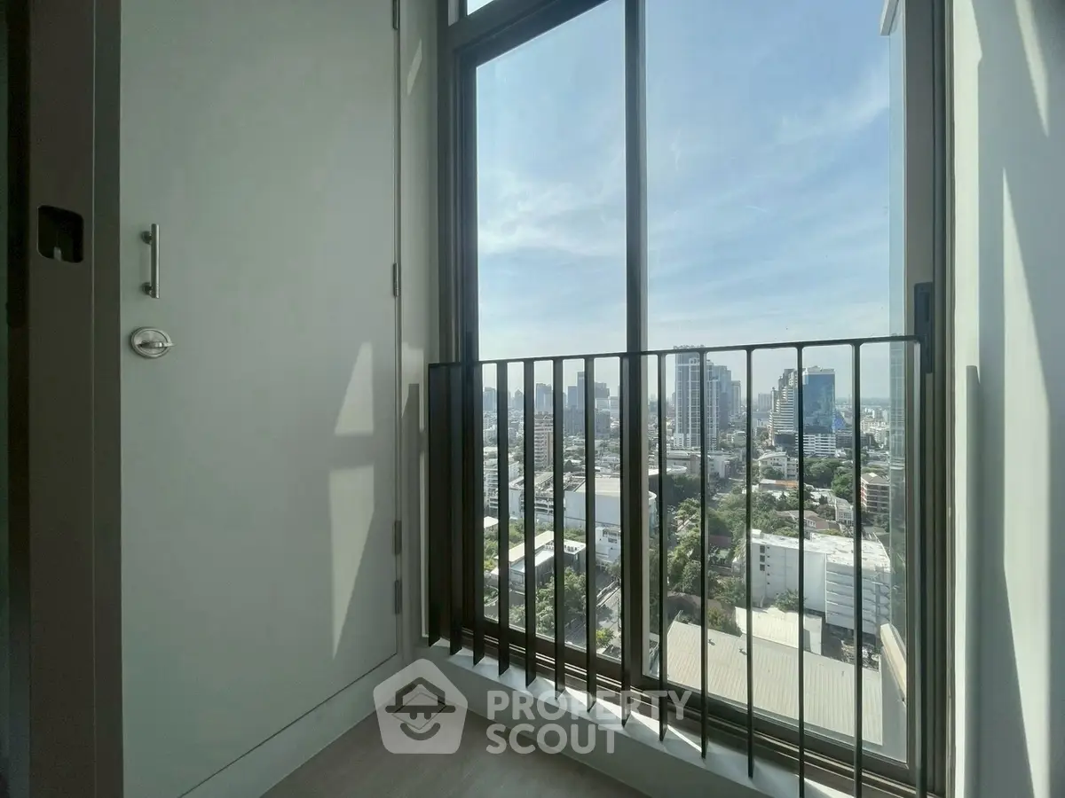 Stunning city view from high-rise apartment balcony with sleek modern design.