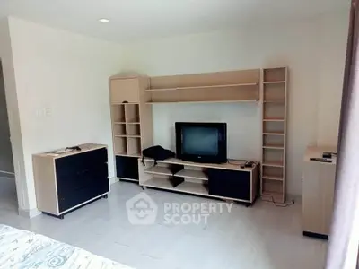 Spacious living room with modern furniture and TV unit, ideal for relaxation.