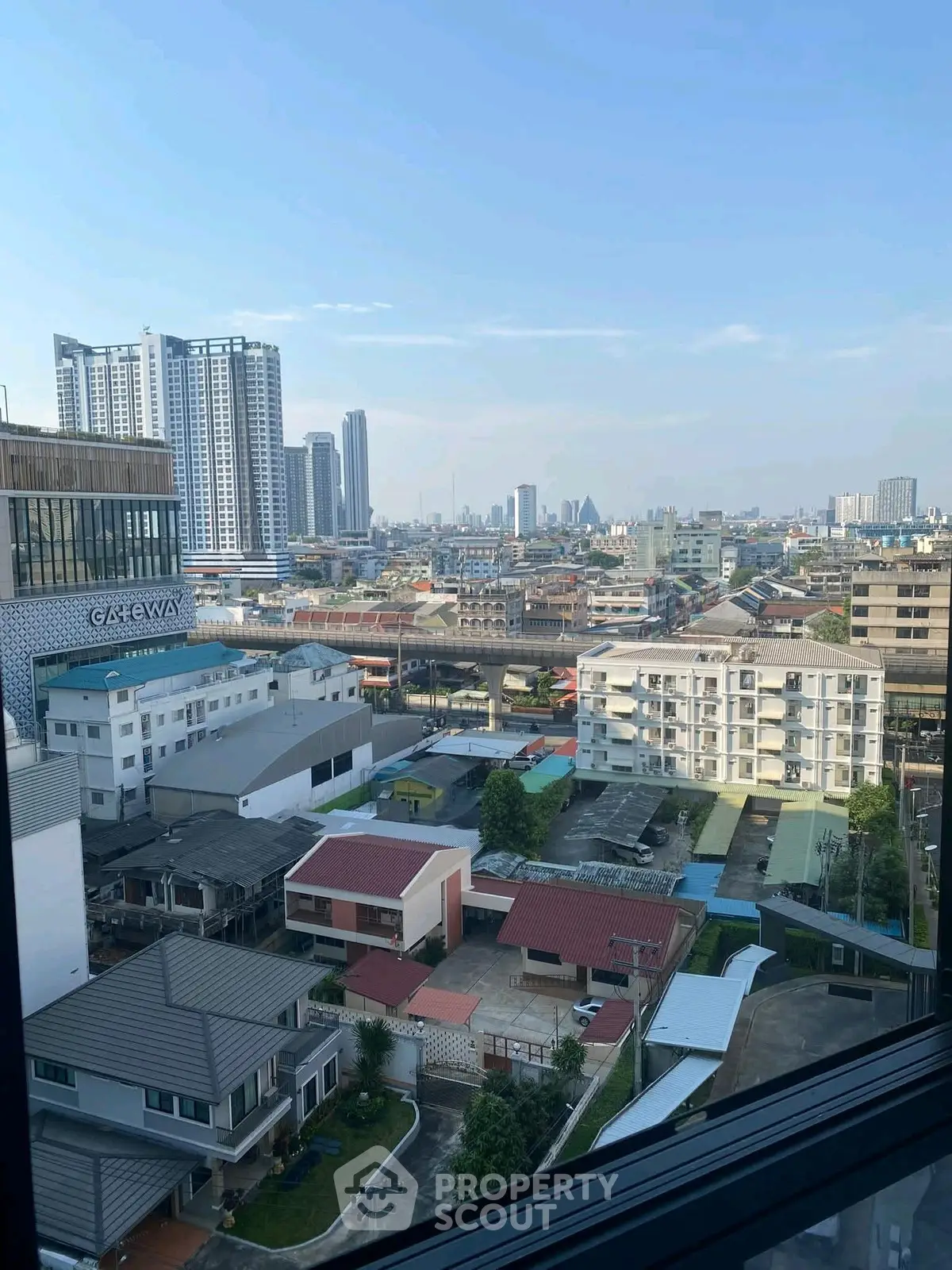 Stunning cityscape view from high-rise building window showcasing urban skyline.