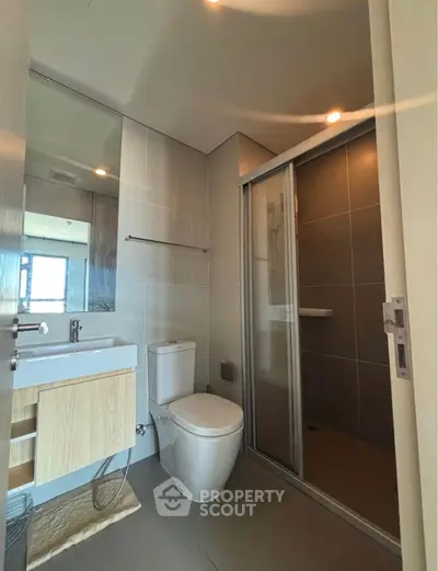 Modern bathroom with sleek fixtures and glass shower enclosure