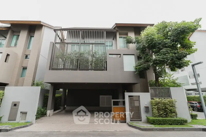 Modern townhouse exterior with sleek design and lush greenery
