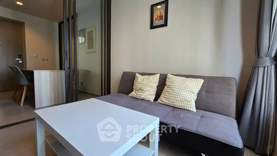 Modern living room with cozy sofa and stylish decor in a contemporary apartment.