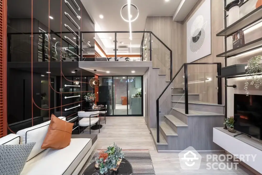 Modern duplex living room with stylish decor and mezzanine level, featuring sleek design and contemporary furnishings.